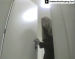An articulated hidden camera is set up in a public bathroom right inside of the toilet on the floor. This is most likely Russian or Eastern European.